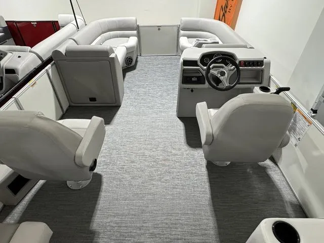 Slide: The Image of 2024 Godfrey Xperience 2286 SBX boat interior with plush seating and modern helm. - 4