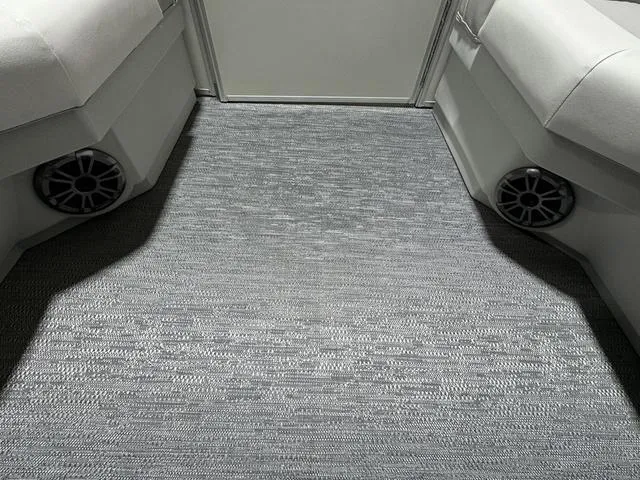 Slide: The Image of 2024 Godfrey Xperience 2286 SBX interior with gray carpet and built-in speakers. - 6