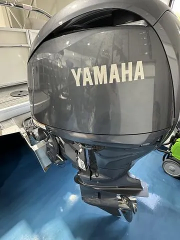Slide: The Image of 2024 Godfrey Xperience 2286 SBX with Yamaha outboard motor in showroom. - 8