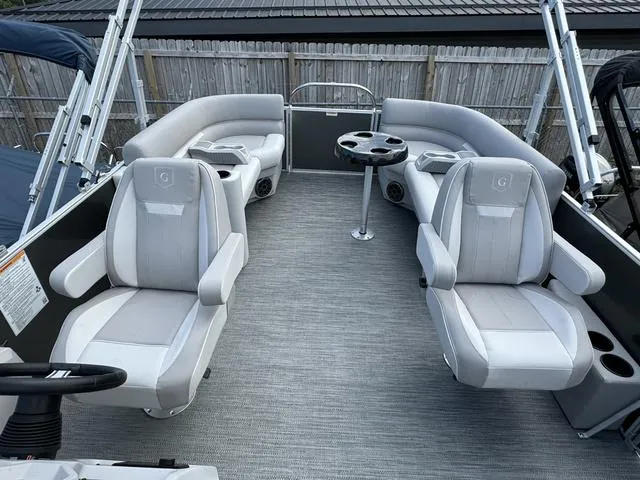Slide: The Image of 2024 Godfrey Xperience 2286 SBX pontoon boat interior with plush seating and table. - 5