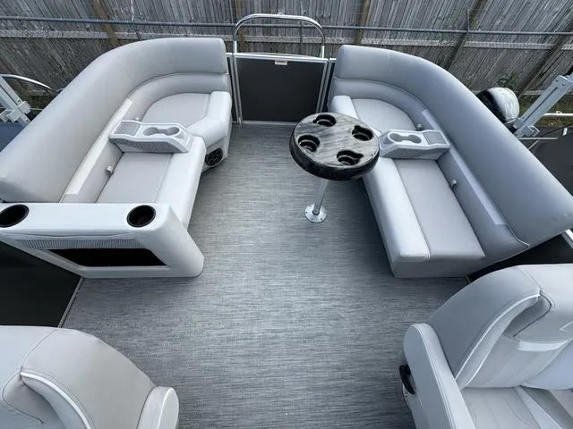 Slide: The Image of 2024 Godfrey Xperience 2286 SBX pontoon boat interior with gray seating and table. - 6