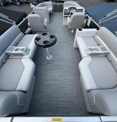 Slide: The Image of 2024 Godfrey Xperience 2286 SBX pontoon boat interior with gray seating and table. - 7