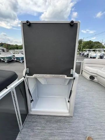 Slide: The Image of 2024 Godfrey Xperience 2286 SBX boat storage compartment open on deck. - 8