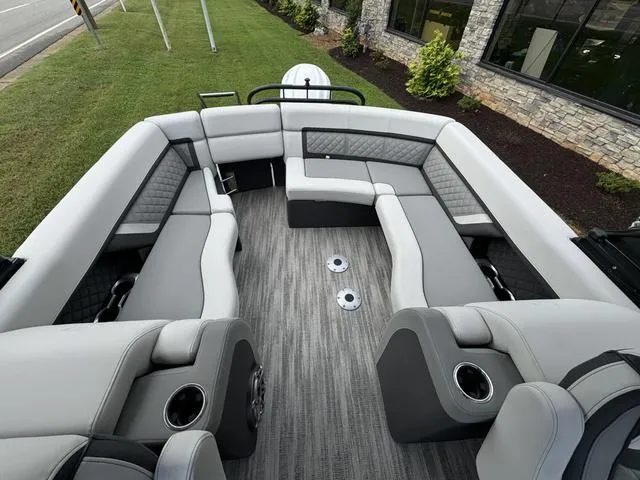 Slide: The Image of 2025 Godfrey AP235 ULW boat interior with luxurious gray seating and modern design. - 12
