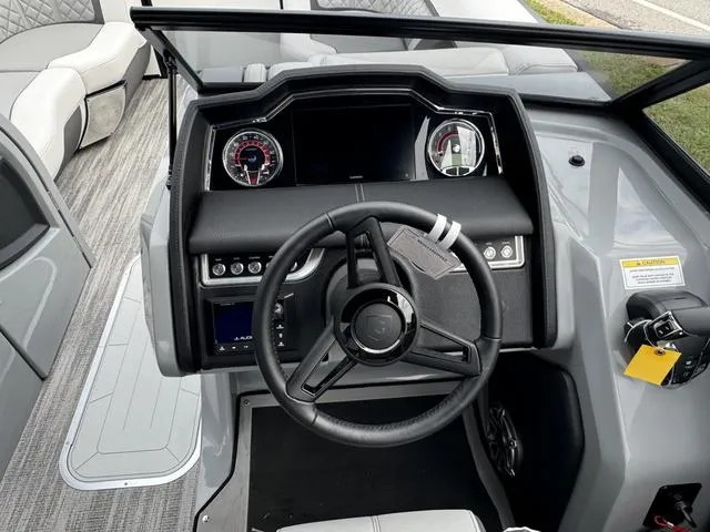 Slide: The Image of 2025 Godfrey AP235 ULW boat dashboard with steering wheel and instrument panel. - 14