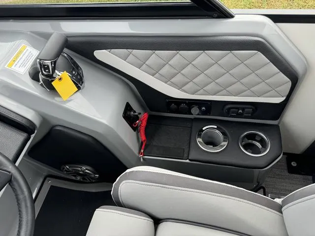 Slide: The Image of Interior of 2025 Godfrey AP235 ULW boat with modern controls and cup holders. - 18