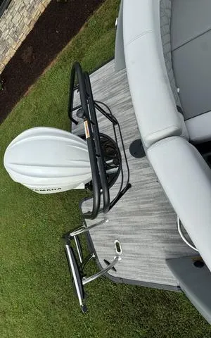 Slide: The Image of 2025 Godfrey AP235 ULW boat with Yamaha motor on grassy area. - 20