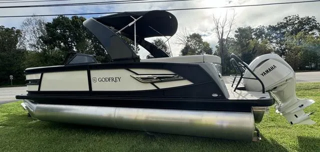 Slide: The Image of 2025 Godfrey AP235 ULW pontoon boat with Yamaha engine on grass. - 4
