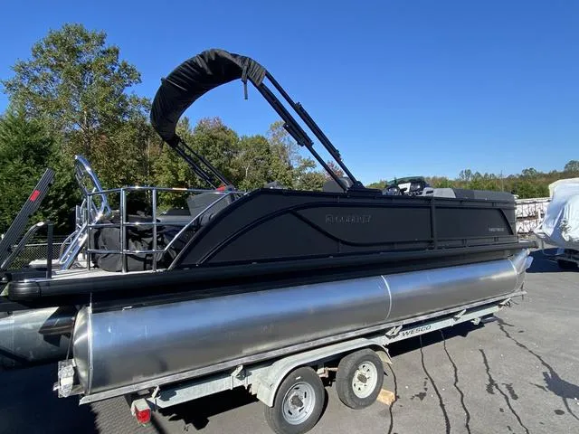 Slide: The Image of 2025 Godfrey SW2286 SFLC pontoon boat on trailer, parked outdoors. - 6