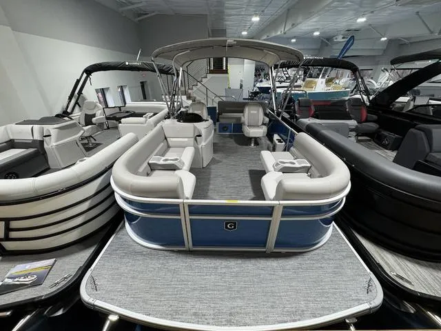 Slide: The Image of 2025 Godfrey EX2286 SFLX pontoon boat in showroom, featuring spacious seating and modern design. - 3