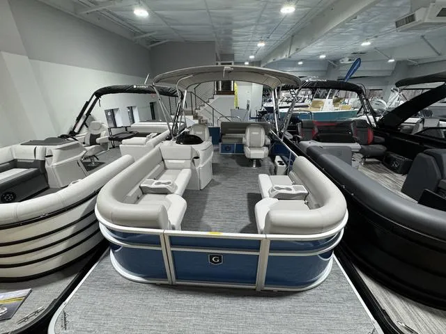 Slide: The Image of 2025 Godfrey EX2286 SFLX pontoon boat in showroom, featuring spacious seating and modern design. - 4