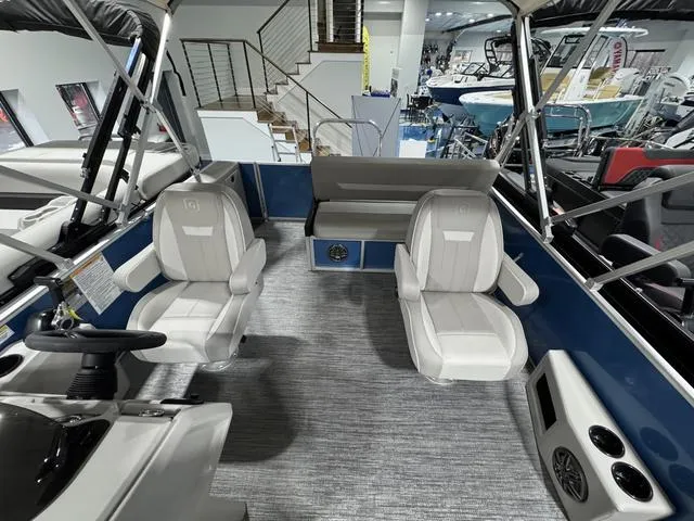 Slide: The Image of Interior of 2025 Godfrey EX2286 SFLX boat with modern seating and controls. - 6