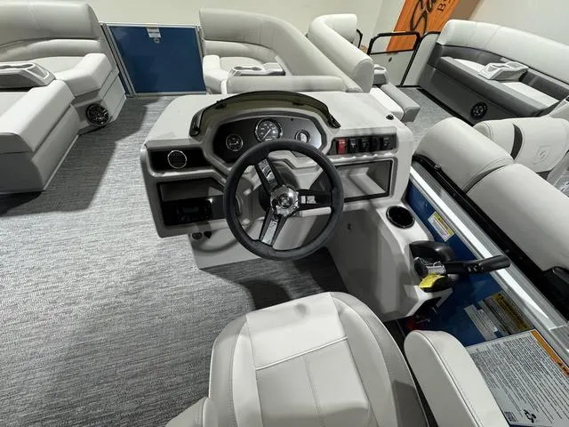 Slide: The Image of 2025 Godfrey EX2286 SFLX boat interior with modern helm and plush seating. - 7
