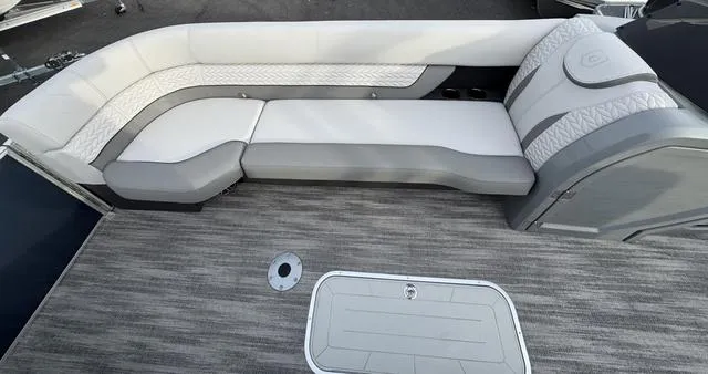 Slide: The Image of 2025 Godfrey MC255SFL boat interior with gray and white seating on a textured floor. - 5
