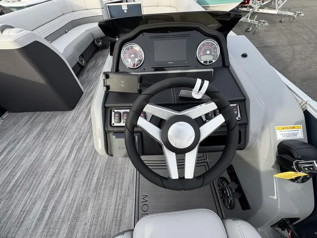 Slide: The Image of Steering console of a 2025 Godfrey MC255SFL boat with modern dashboard and seating. - 6