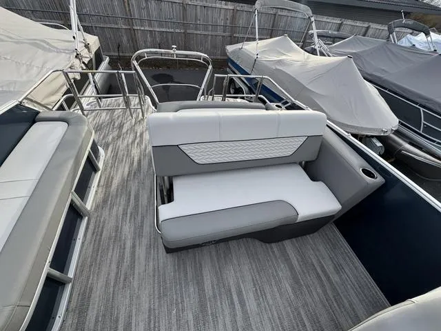 Slide: The Image of 2025 Godfrey MC255SFL boat interior with white seating and gray flooring. - 9