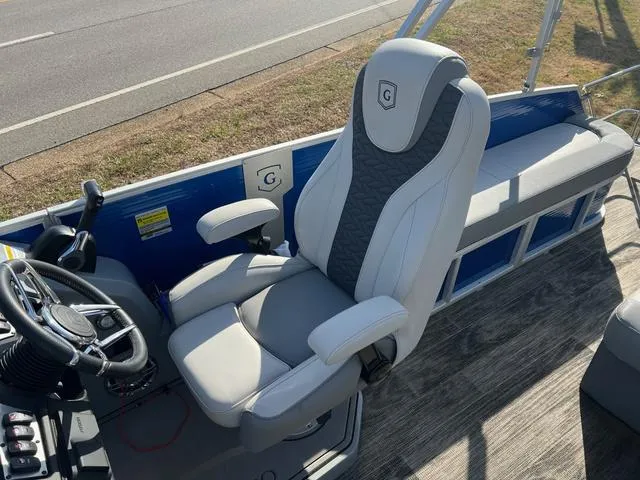 Slide: The Image of 2022 Godfrey Monaco 235 SFL boat interior with captain's chair and bench seating. - 15