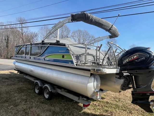 Slide: The Image of 2022 Godfrey Monaco 235 SFL pontoon boat on trailer, parked outdoors. - 16