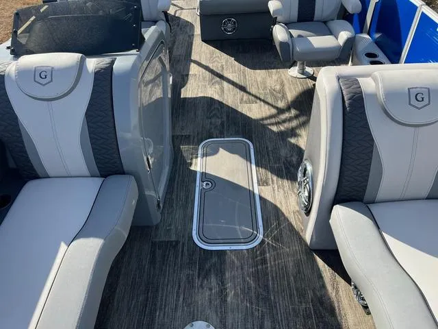 Slide: The Image of Interior of 2022 Godfrey Monaco 235 SFL boat with luxurious seating and wood-style flooring. - 21