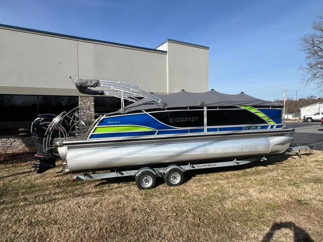 Slide: The Image of 2022 Godfrey Monaco 235 SFL pontoon boat on trailer, parked outdoors. - 3
