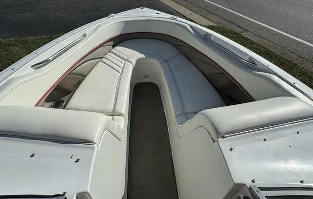Slide: The Image of 2005 Cobalt 262 boat interior with white seating and red trim. - 11