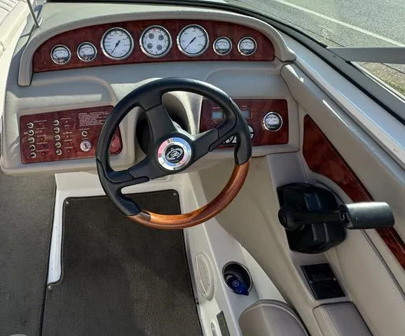 Slide: The Image of 2005 Cobalt 262 boat dashboard with steering wheel and gauges. - 14