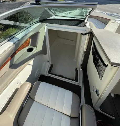 Slide: The Image of Interior of a 2005 Cobalt 262 boat, featuring seating and storage area. - 16