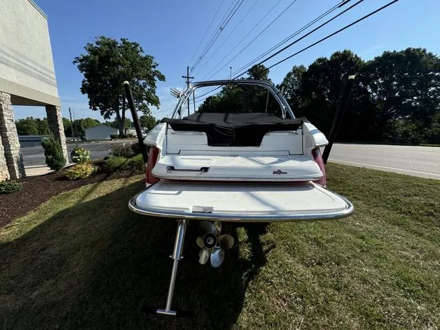 Slide: The Image of 2005 Cobalt 262 boat with open swim platform, parked on grass. - 6