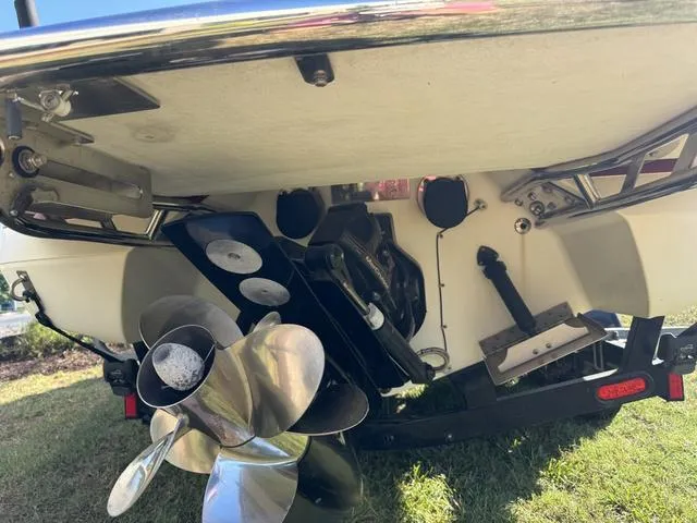 Slide: The Image of Close-up of a 2005 Cobalt 262 boat's propeller and stern on grass. - 8