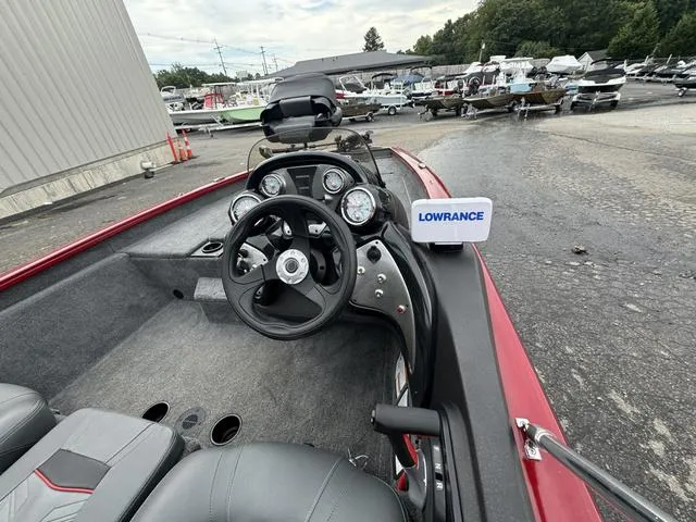 Slide: The Image of 2024 Tracker Pro Team 175 boat interior with steering wheel and Lowrance device. - 3