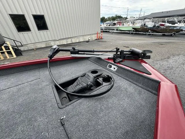 Slide: The Image of 2024 Tracker Pro Team 175 boat deck with trolling motor in a marina setting. - 4