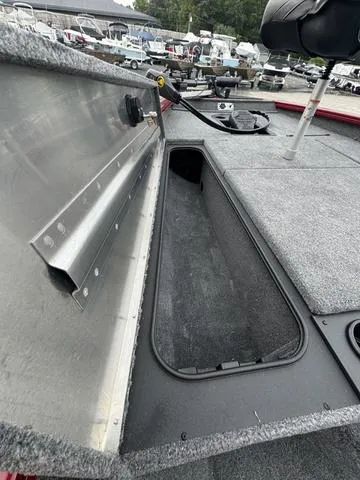Slide: The Image of 2024 Tracker Pro Team 175 boat storage compartment with carpeted interior. - 6
