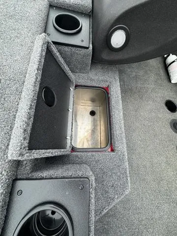 Slide: The Image of 2024 Tracker Pro Team 175 boat interior with storage compartment and cup holders. - 7