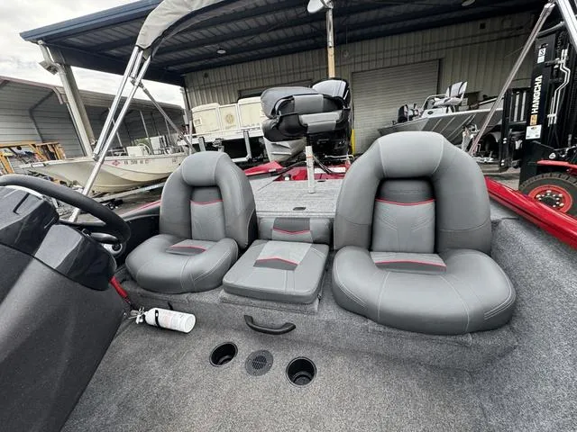 Slide: The Image of 2024 Tracker Pro Team 175 boat interior with gray seating and steering wheel. - 9