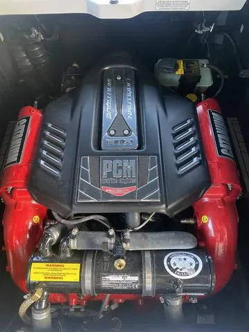 Slide: The Image of 2014 Nautique Super Air G23 engine with PCM branding and red accents. - 12