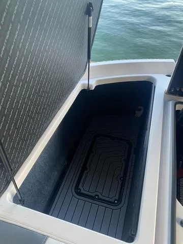Slide: The Image of Open storage compartment in 2014 Nautique Super Air G23 boat. - 14