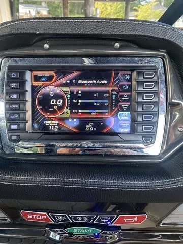 Slide: The Image of 2014 Nautique Super Air G23 dashboard with touchscreen controls and Bluetooth audio display. - 16