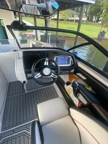 Slide: The Image of 2014 Nautique Super Air G23 boat interior with steering wheel and dashboard. - 20