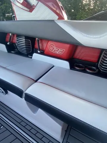 Slide: The Image of 2014 Nautique Super Air G23 interior with red and white seating. - 24