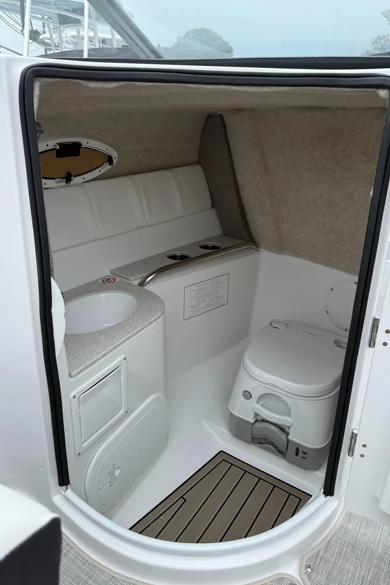 Slide: The Image of 2025 Stingray 211 DC boat interior with white seating and modern design. - 6