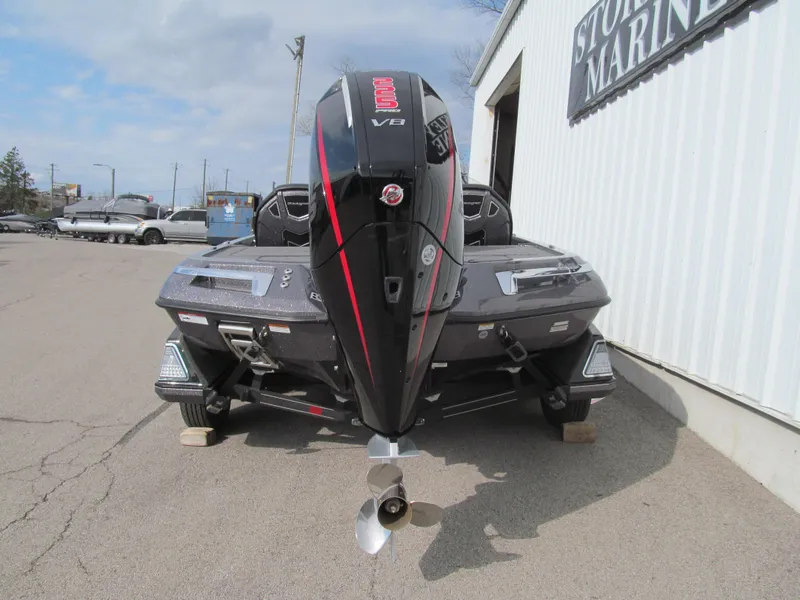Slide: The Image of 2025 Ranger Z519R Cup-Equipped boat with powerful outboard motor, parked outside a marine store. - 4