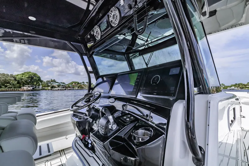 Slide: The Image of 2019 HCB 53 boat cockpit with advanced navigation system and luxurious seating. - 10