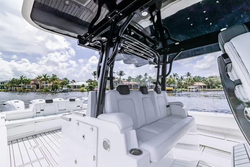 Slide: The Image of 2019 HCB 53 boat interior with luxurious seating and waterfront view. - 11