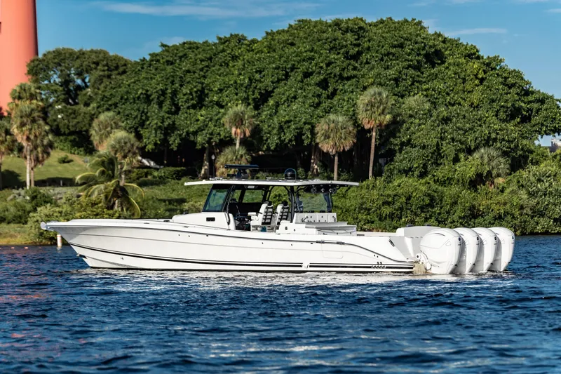 Slide: The Image of 2019 HCB 53 boat cruising on a scenic waterway with lush greenery. - 3