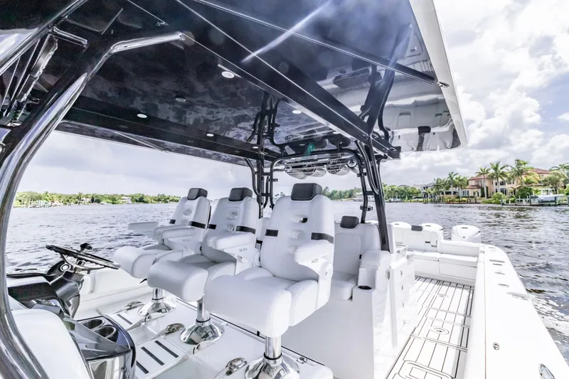 Slide: The Image of 2019 HCB 53 boat interior with luxurious seating and sleek design on a sunny day. - 9