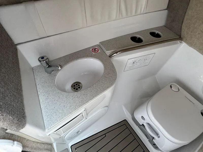 Slide: The Image of 2025 Stingray 211 DC boat interior with sink and portable toilet. - 11