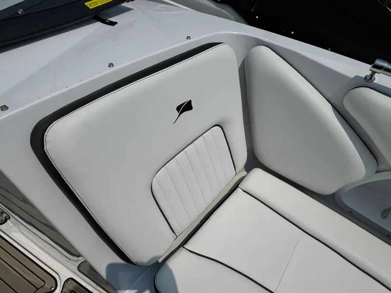 Slide: The Image of 2025 Stingray 211 DC boat interior with white cushioned seating and sleek design. - 14