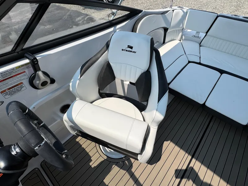Slide: The Image of 2025 Stingray 211 DC boat interior with sleek seating and modern steering wheel. - 20