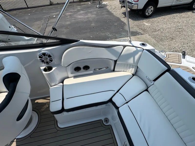 Slide: The Image of 2025 Stingray 211 DC boat interior with white seating and cup holders. - 3