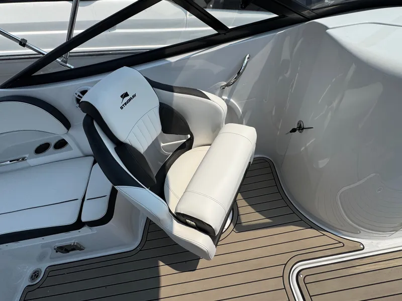 Slide: The Image of 2025 Stingray 211 DC boat interior with white and black seating, modern design. - 6